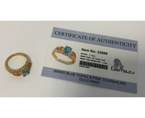 A Swiss blue topaz and pink tourmaline ring set in 9 carat. Approx. 3.69 grams. Est. £25 - £35.