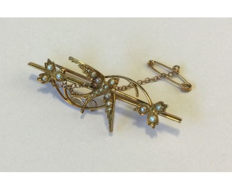 A Victorian pearl brooch decorated with a swallow set in 18 carat gold. Approx. 4 grams. Est. £50 - £80.