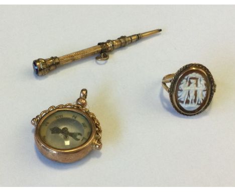 A small 9 carat pencil together with a compass and cameo ring. Approx. 13 grams. Est. £40 - £50.