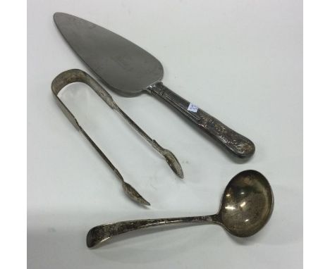 A pair of Georgian silver sugar tongs together with a ladle etc. Approx. 203 grams. Est. £20 - £30.