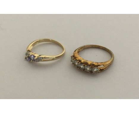 A diamond mounted and tanzanite ring together with another gem set ring set in 9 carat. Approx. 5 grams. Est. £50 - £80.