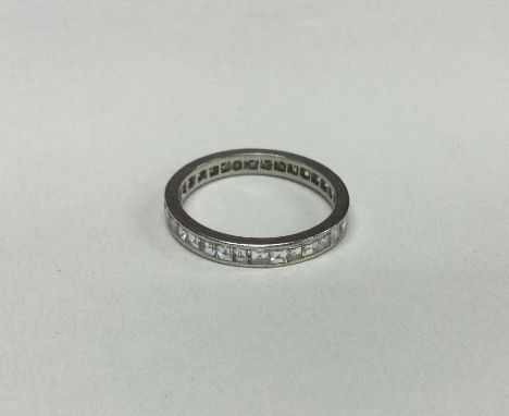 A good platinum mounted princess cut diamond full eternity ring. Approx. 3 grams. Est. £500 - £800.