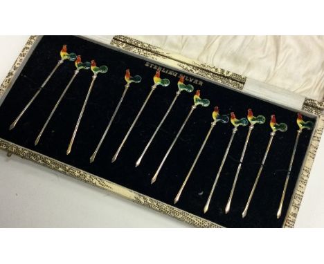 A set of twelve silver and enamel cocktail sticks. Approx. 40 grams. Est. £200 - £300.