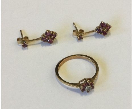A small ruby and diamond cluster ring together with matching earrings set in 9 carat. Approx. 2 grams. Est. £30 - £40.