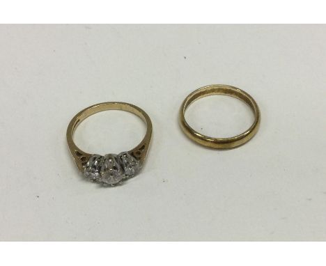 A 9 carat three stone ring together with a plain wedding band. Approx. 5 grams. Est. £50 - £80.