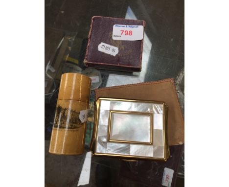 Crown, compact and a tape in a boxwood tube 