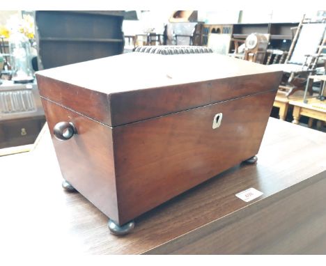 A Georgian mahogany tea caddy of sarcophagus form. 