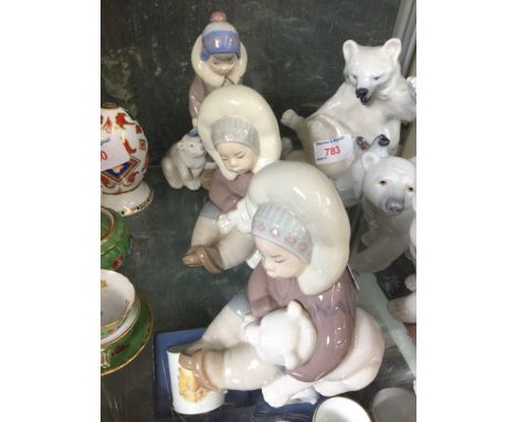 Three Lladro Eskino figuresCondition: No damage or repairs, some sticker residue present, heights - 15cm, 12.5cm, 12.5cm.