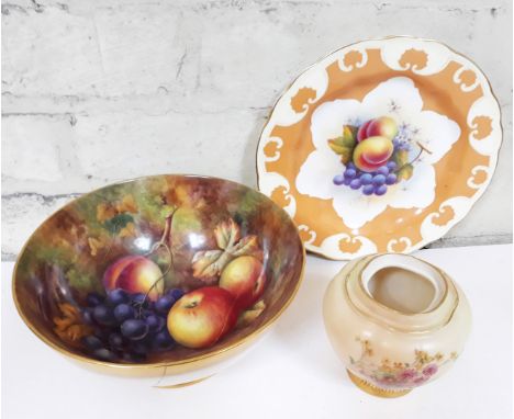 Three pieces of Royal Worcester comprising a bowl hand painted with fruit by Price, a blush ivory pot and a plate. 