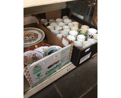 A box of commemorative plates and a box of mugs 