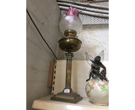 A Victorian style Corinthian column oil lamp with cranberry and etched glass shade. 