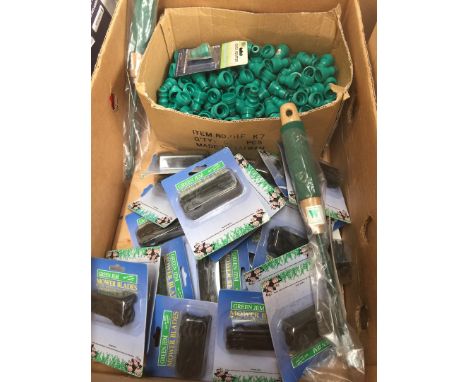 A box containing hose pipe fittings and mower blades 
