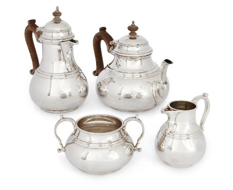 A matched four piece silver tea service, comprising teapot, hot water pot and milk jug, London, 1923 and 1924, Charles and Ri