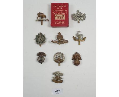 A good selection of cap badges, Borde regiment etc. and a pack of US government 1945 aviator playing cards 