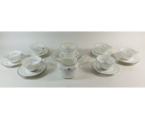 A Royal Worcester tea set in the Bridal Wreath pattern, consisting of six trios, one cake plate, milk jug and sugar bowl. 