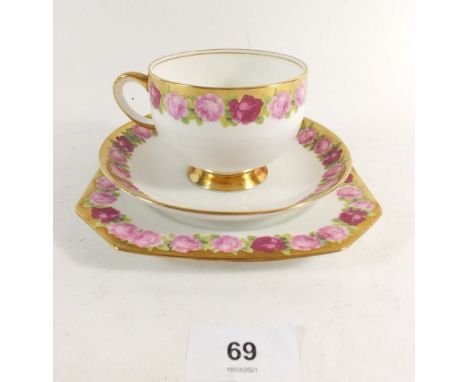 A Standard China tea service with rose printed borders No. 3592 comprising: two cake plates, milk, sugar, twelve cups and sau
