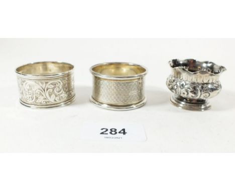 Two silver serviette rings, Sheffield 1948 &amp; 1919, 34g and a Victorian small silver frilled top pot with embossed decorat