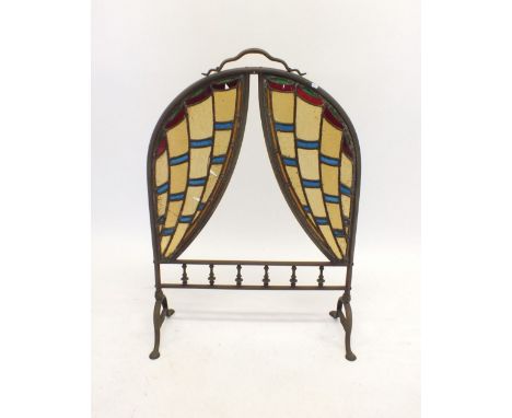 A brass Arts &amp; Crafts stained glass firescreen with theatre curtain design, glass a/f 