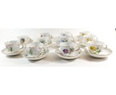 A 20th century Meissen tea service comprising  eleven cups and saucers painted sprays and posies of garden flowers, crossed s