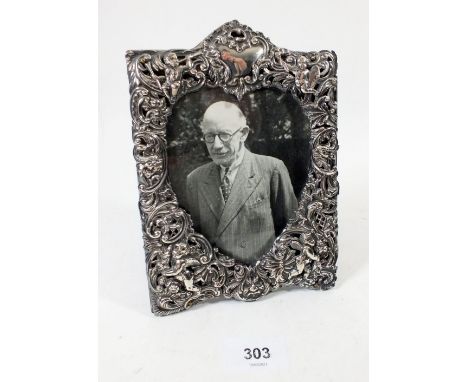 A fine Victorian silver photograph frame with pierced and embossed cherub and scrollwork decoration, London 1898 by William C