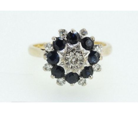 An 18ct yellow and white gold sapphire and diamond cluster ring, 5.3g, Size M, 1.5cm diameter 