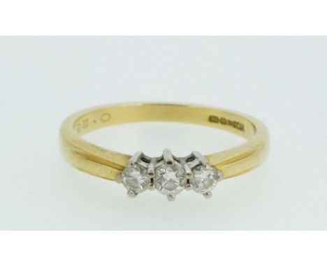 An 18ct gold three stone diamond ring, size M. Weight approx 3.1g