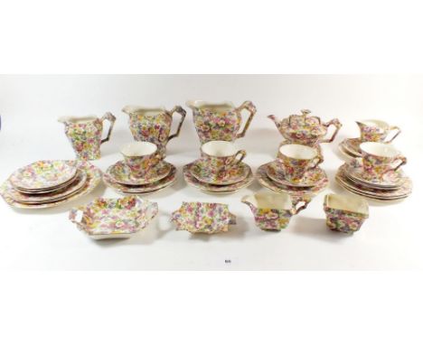 A James Kent 'Du Barry' Chintz part tea service comprising: three graduated jugs, teapot &amp; stand, milk jug, cream jug, su