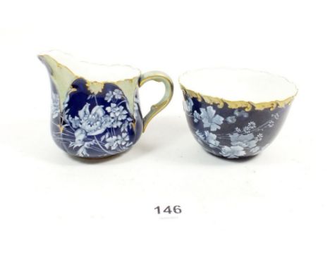 A Royal Worcester cream jug and sugar with Pate-sur-Pate style floral decoration 