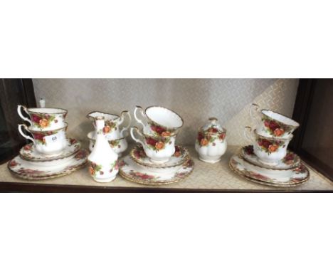 A Royal Albert Country Roses tea service comprising: six cups and saucers, six tea plates, milk and sugar, posy vase and lidd