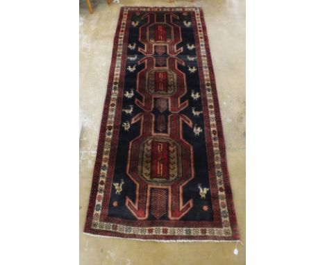 A multicoloured ground thick pile Iranian runner with Aztec design, 305 x 120cm 