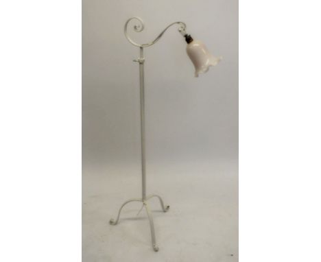 An Art Nouveau white painted extending standard lamp on triple supports, with glass frilled shade 