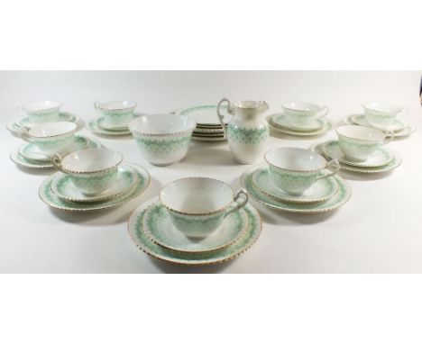 An early 20th century green printed tea service, to include 9 cups, 10 saucers, 10 tea plates, 3 sandwich plates milk jug and