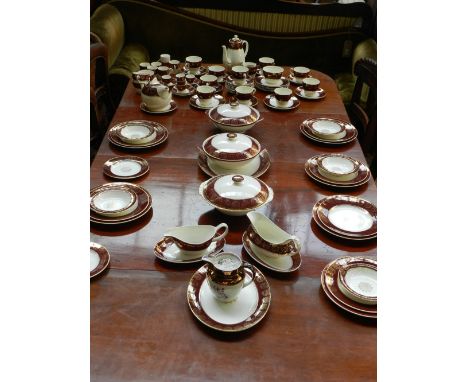 A late 19th / early 20th century Midwinter dinner, tea and coffee part service, decortaed with gilt foliate borders on claret