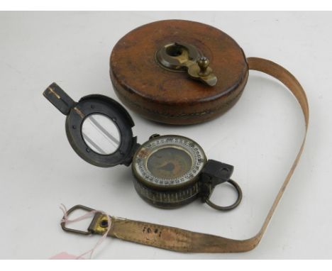 A Rabone's Rigida measuring tape in a circular leather case, together with a brass compass. (2)