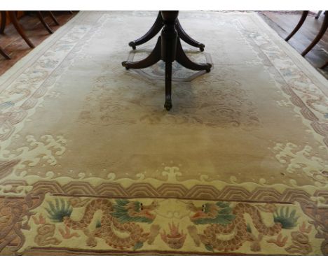 A large Chinese cream ground carpet, having octagonal medallion to centre with dragon, the border having dragons and scrollin