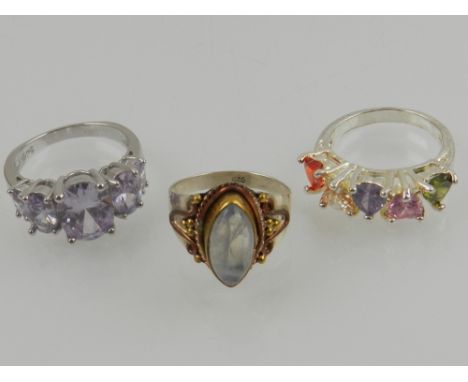 A silver, copper and moonstone ring, together with a silver and amethyst style ring, and a multi-coloured gem ring. (3)