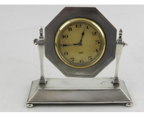 An Art Deco silver mantle clock, having engine turned base, hallmarked Birmingham 1927. H.10.5cm W.12cm