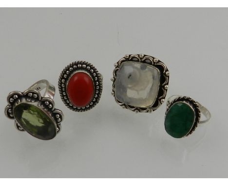 A silver and quartz set ring, together with three further white metal rings. (4)