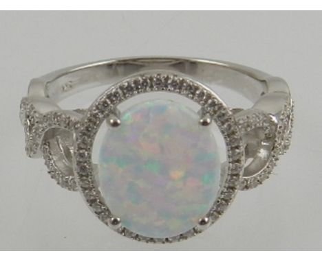 A silver, opalite, and cubic zirconia set cocktail ring.
