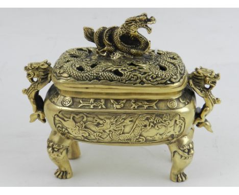 A Chinese polished brass twin-handled incense burner, moulded with dragons, bears seal mark to base. H.15cm