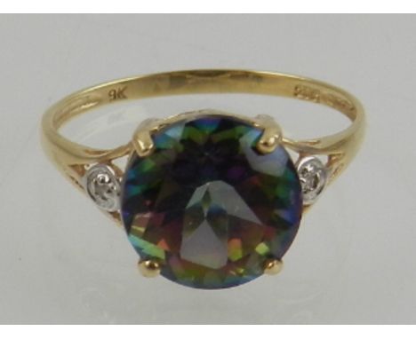 A 9 carat yellow gold and mystic topaz ring, the shoulders set with small diamond accents. 