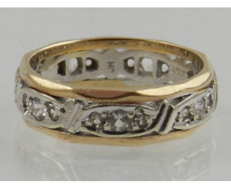 A 9 carat yellow and white gold and diamond set eternity ring. 