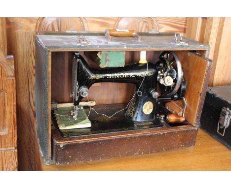 A cased Singer sewing machine, the case is faux crocodile skin
