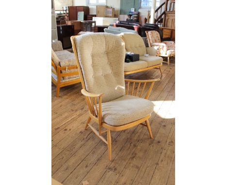 An Ercol blonde beech wing back armchair 