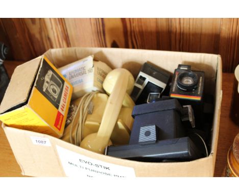 A selection of vintage Polaroid cameras, retro telephone etc