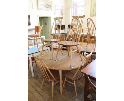 An Ercol beech and elm drop leaf dining table and six chairs