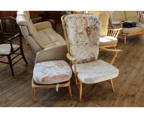 An Ercol beech wing back armchair with foot stool