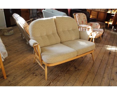 An Ercol blonde beech two seater sofa