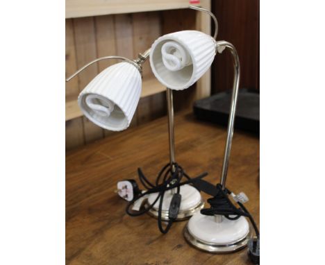 A pair of retro style chrome table lamps with ceramic shades