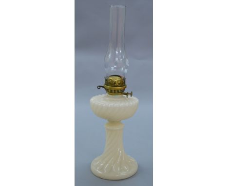 An opaque pearl white glass oil lamp. 55cm tall 